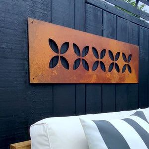 Side view of large corten steel frangipani garden wall art for outdoors by LisaSarah Steel Designs NZ.