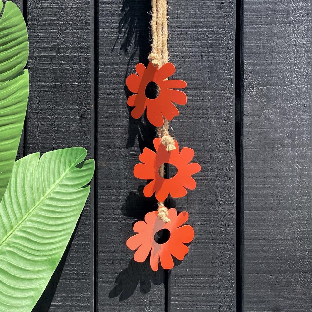 Orange flowers wall hanging on outdoor fence in New Zealand.  LisaSarah Steel Designs