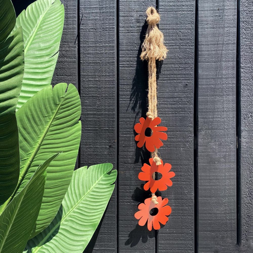 Orange flowers wall hanging on outdoor fence in New Zealand.  LisaSarah Steel Designs