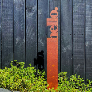 Hello corten steel garden stake in New Zealand garden by LisaSarah Steel Designs