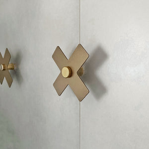 Side view gold coat hooks on bathroom wall by NZ Designer, Lisa Turley